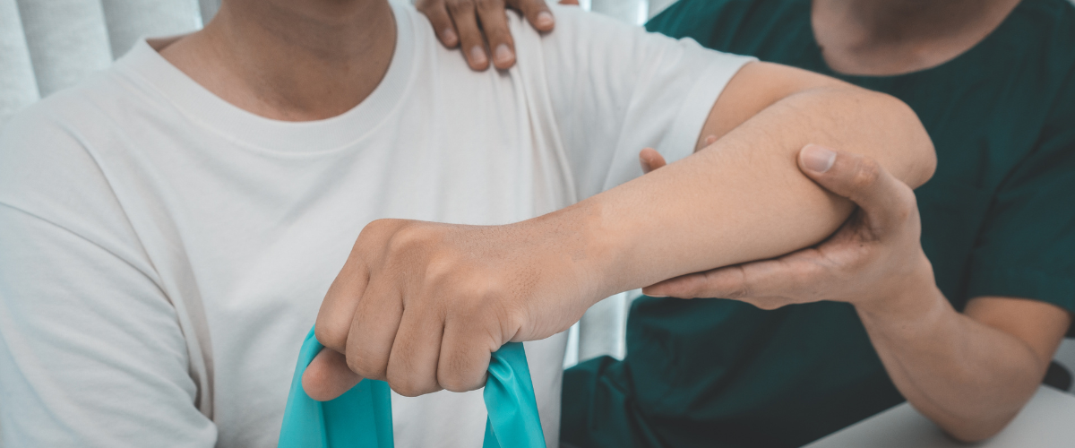 person having their arm stretched by another person during an assisted stretching session