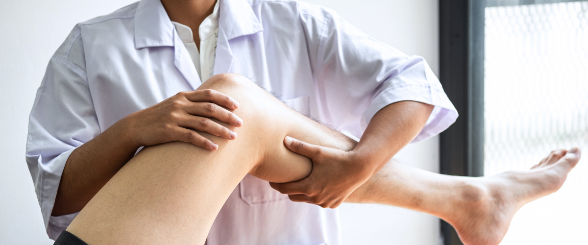 person having their leg stretched by another person during an assisted stretching session